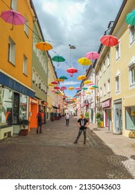Villach, Austria - 08.30.2021: Lederergasse colorful street with floating umbrellas