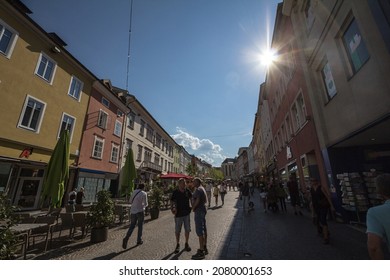 VILLACH, AUSTRIA - SEPTEMBER 13, 2021:Crowd of people on the pedestrian street of hauptplatz in Villach, surrounded with shops, stores, in summer. Villach is a city of Carinthia. 