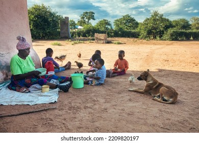 Village African Family  Eating Together In The Yard Granny And Grandchildren