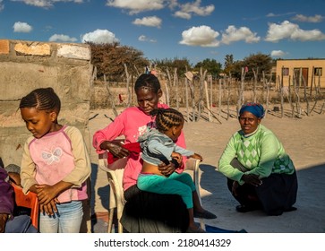 Village African Family, Other, Granny And Two Braided Girls Sited In The Yard