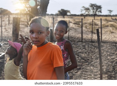 village african kids , playing in the yard at sunset - Shutterstock ID 2395517633