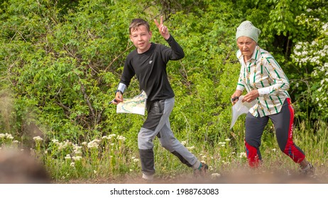 Village Aktovo, Ukraine - May 21, 2021: Orienteering Race. Traditional Annual Game. Young Athlete During Orienteering