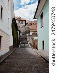 A village alleyway with stairs ascending in Skofja Loka, Slovenia