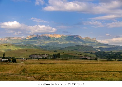 Village in the background of the rocky mountains in the Karachaevo-Cherkess Republic, Russia - Shutterstock ID 717040357