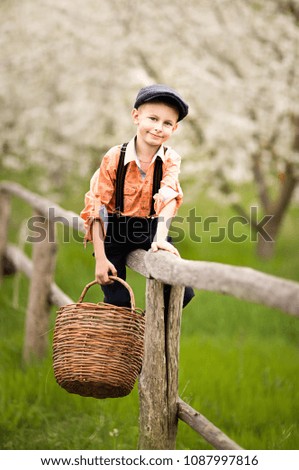 Similar – Happy kid putting apple in wicker basket with harvest