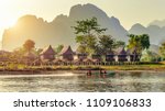 Village and bungalows along Nam Song River in Vang Vieng, Laos.
