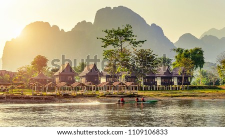 Village and bungalows along Nam Song River in Vang Vieng, Laos.