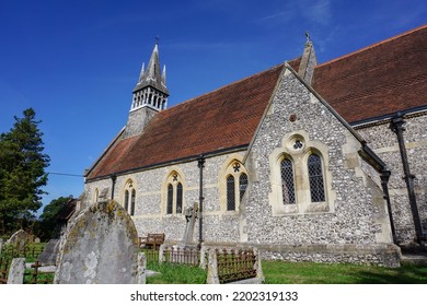 Village Church In English Countryside. Traditional Stone Church Viewed Form Graveyard. Quaint Religious Building In UK