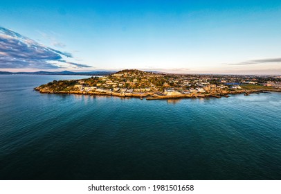 Village of Dalkey, Co. Dublin, Ireland - March 2021: Aerial drone panoramic still image. View of Dalkey village at golden sunrise.