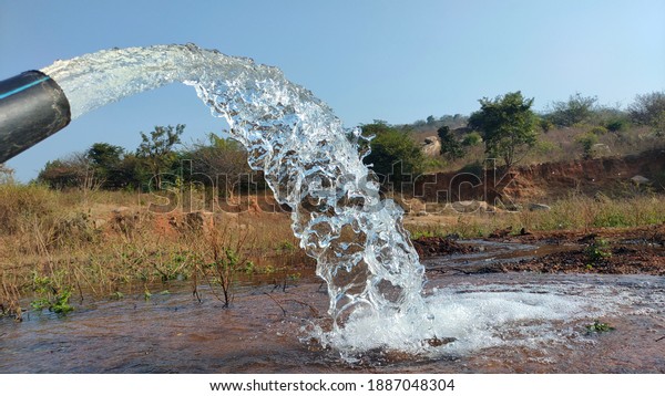 village farming bore water and village cheruv , river\
water water slow motion pictures, pump water slow motion pictures,\
dry grass  