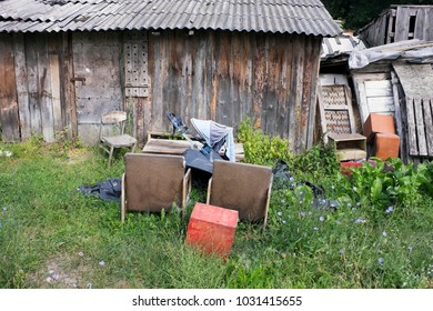 A village garbage dump near wooden destroyed sheds. Summer August day European resl landscape - Shutterstock ID 1031415655