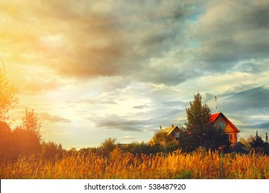 village house on field and cloudy sky autumn background. - Powered by Shutterstock