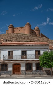 The village La Calahorra, in the province of Granada, Spain with Castillo de La Calahorra on top of hill. It is situated in the Sierra Nevada foothills.