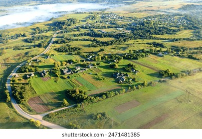 Village in morning mist. Farm house rural fog. House in rural landscape, drone view. Countryside at dawn in fog, aerial view. Roofs of Country houses in Foggy dawn. Rural landscape, aerial view. - Powered by Shutterstock