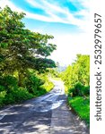 Village road and path through natural land and forest with mountains in Para Heredia Costa Rica in Central America.