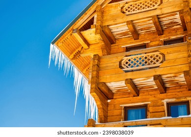 village rural house,mansion,hotel covered in snow,big icicles in winter mountains,nature. Calm countryside. Home residence in coniferous trees.Eco concept.