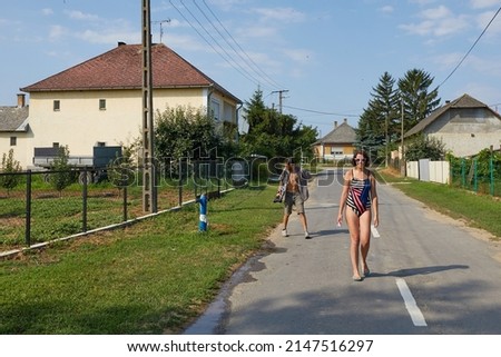 Similar – Happy young people walking along road in summer day