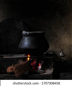 A Villager's Cooking Setup, With A Pot Usually Used For Cooking Rice. Dry Wood Is Used For Fire. The Darkness In The Image Gives It A Vintage Look.