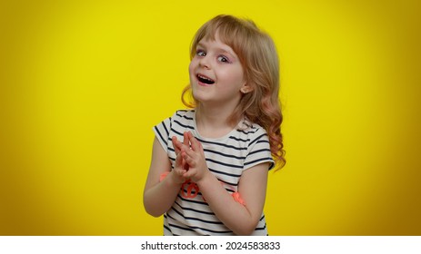 Villain Idea. Sneaky Playful Blonde Child Girl Conspiring Scheming, Thinking Over Tricky Plan With Cunning Expression, Pondering Revenge Or Evil Joke Prank. Teen Kid Children On Yellow Background