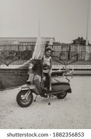 VILLANOVA DEL GHEBBO, ITALY JUNE 1964: Little Girl Sitting On The Vespa In 50s