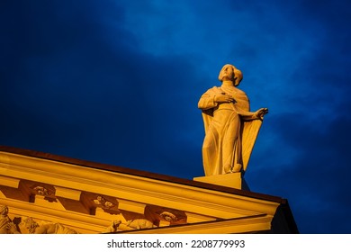 Vilnius, Lithuania - 31 August 2022: Woman Statue On Roof Top Of The Catholic Cathedral Golden Hour Cloudy Sky