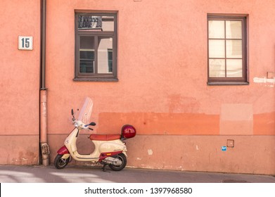Vilnius, Lithuania, April 2019 - An old scooter parked on the pavement in the old town.