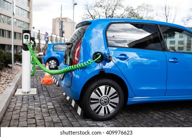 Vilnius, Lithuania - April 23, 2016: Power supply for electric car charging. Electric car charging station. Close up of the power supply plugged into an electric car being charged.