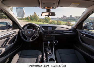 VILNIUS, LITHUANIA - AUGUST 10, 2020: Interior Of BMW X1 2012 Year Compact Sport Utility Vehicle. Beautiful Sunny Cityscape Background.