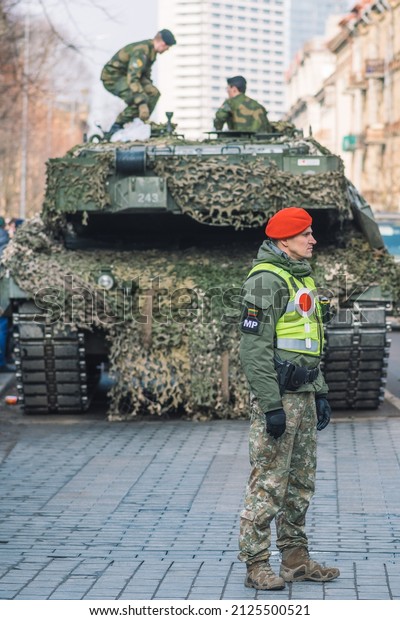 Vilnius, Lithuania -\
February 16 2022: NATO response force or North Atlantic Treaty\
Organization armored crawler tanks and other military vehicles in\
Lithuania with\
soldiers