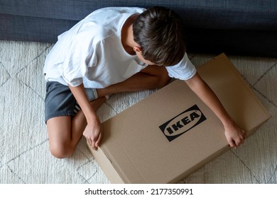 Vilnius, Lithuania - July 7, 2022: Teenage Boy Assemble Ikea Furniture At Home. IKEA Is Swedish-founded, World's Largest Furniture Retailer