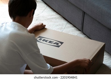 Vilnius, Lithuania - July 7, 2022: Teenage Boy Assemble Ikea Furniture At Home. IKEA Is Swedish-founded, World's Largest Furniture Retailer