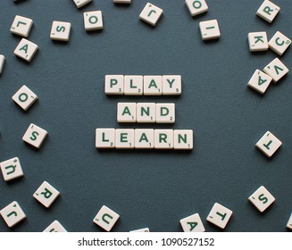 Vilnius, Lithuania, May 14, 2018: PLAY AND LEARN Words Made From Scrabble Game Tiles On Green Background. Education And Learning Concept.