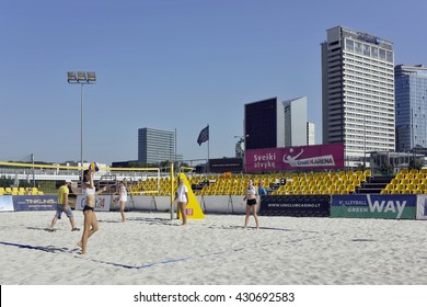 VILNIUS, LITHUANIA - MAY 29, 2016: Morning training of women's Lithuanian team on beach volleyball on the river bank of Neris. On the back plan - Radisson hotel and buildings of DNB and Swedbank