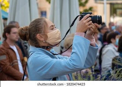 Vilnius, Lithuania - September 20 2020: Beautiful Girl With Mask Taking Photos With Camera During Covid Or Coronavirus Outbreak In A Public Event, Music Festival, Concert