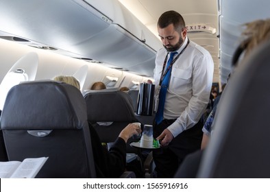 VILNIUS, LITHUANIA - SEPTEMBER 23, 2019: SAS Airlines Cabin Crew Serving Tea And Coffee In Airplane.