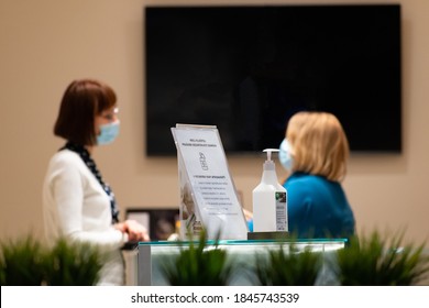 Vilnius, Lithuania - September 28 2020: Nurse, Receptionist Or Doctor And Patient At Clinic, Hospital Reception Desk, Waiting Area, Examination Room, Wearing Mask During Covid Or Coronavirus Exam Test