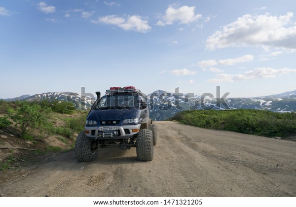 Vilyuchik, Kamchatka / Russia - July 22 2019:\
Heightened four wheel truck for driving in all terrains. Volcanic\
mountainous area. Road to Mutnovsky thermal power station next to\
Vilyuchinsky\
volcano.