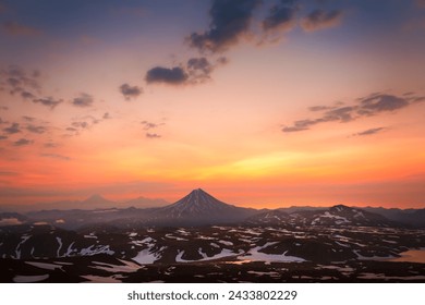 Vilyuchinsky volcano at sunrise in Kamchatka, Russia. Volcanoes against the pink sky with clouds. Beautiful summer landscape - Powered by Shutterstock