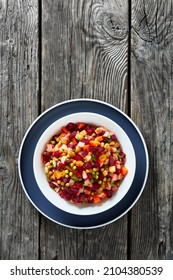 Vinegret, Russian Vinaigrette, Salad Of Diced Cooked Vegetables Red Beets, Potatoes, Carrots, Chopped Onions, Brined Pickles, Green Peas In A Bowl On A Wooden Table, Vertical View,  Free Space