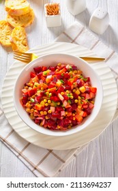 Vinegret, Russian Vinaigrette, Salad Of Diced Cooked Vegetables Red Beets, Potatoes, Carrots, Chopped Onions, Brined Pickles, Green Peas In A White Bowl On A White Table, Vertical View,  Close-up