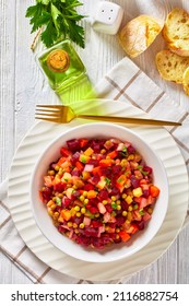 Vinegret, Russian Vinaigrette, Salad Of Diced Cooked Vegetables Red Beets, Potatoes, Carrots, Chopped Onions, Brined Pickles, Green Peas In A White Bowl On A Wooden Table, Vertical View,  Close-up