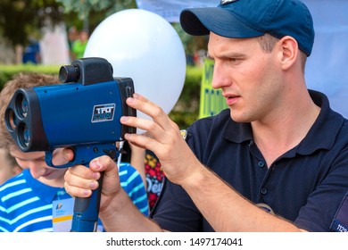 Vinnitsa. Ukraine. 07/20/2019. Policeman Applies Laser Speed Gun. Cop Holds TruCAM Radar. Traffic Speed Control Concept