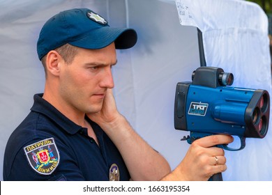 Vinnitsa. Ukraine. 07/20/2019. Policeman Applies Laser Speed Gun. Cop Holds TruCAM Radar. Traffic Speed Control Concept