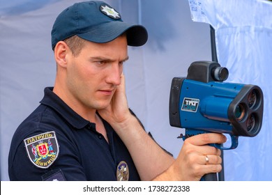 Vinnitsa. Ukraine. 07/20/2019. Policeman Applies Laser Speed Gun. Cop Holds TruCAM Radar. Traffic Speed Control Concept