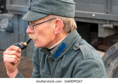 Vinnitsa. Ukraine. 10/12/2019. Man Holding A Pipe. Old Military Man. Retro Military Man. Smoking Addiction. Tobacco Pipe