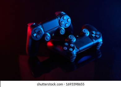 Vinnitsa, Ukraine - April 03, 2020. Sony Playstation 4 (PS4) DualShock 4 controllers, videogame joysticks or gamepad. Close up studio shot
