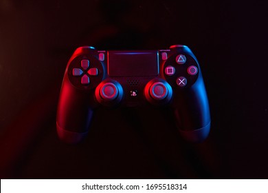 Vinnitsa, Ukraine - April 04, 2020. Sony Playstation 4 (PS4) DualShock 4 controller, videogame joystick or gamepad on a table. Close up studio shot. Game concept
