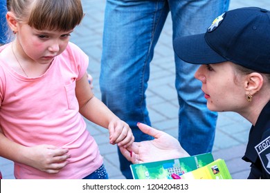 Vinnytsia, Ukraine. 22.09.2018. The Woman The Police Officer Calms The Aggrieved Little Girl. The Cop Talks To The Child. The Concept Police Loves Children.