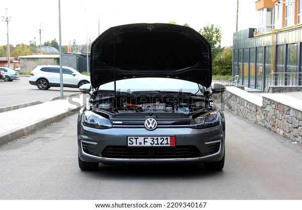 Vinnytsia, Ukraine; October 01, 2022.\
German electric car Volkswagen e-Golf open hood. Volkswagen eGolf\
electric engine. Broken engine electric car. Front\
view.
