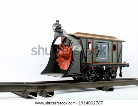 A vintage 0 gauge toy railway snow plough made by Bing of Germany on a plain white background.